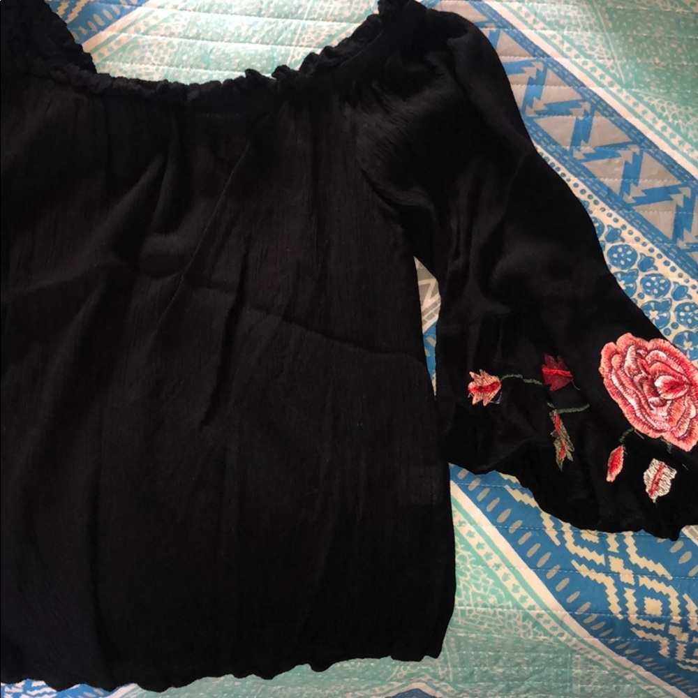 Black off the shoulder shirt with roses on sleeves